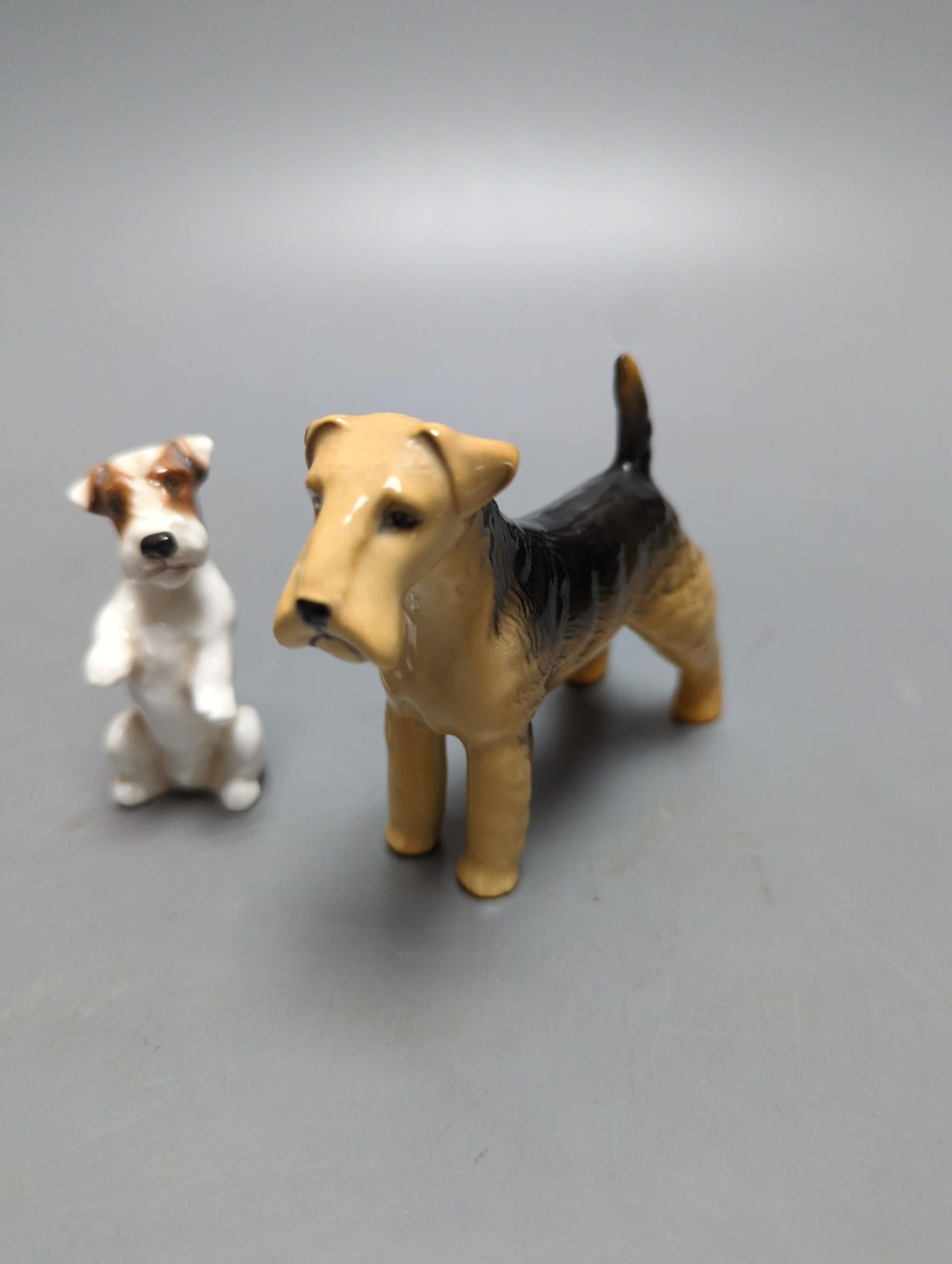 A large Royal Doulton figure of a seated Labrador (No. 2314), height 34cm, a small Beswick Airedale Terrier and another (3)